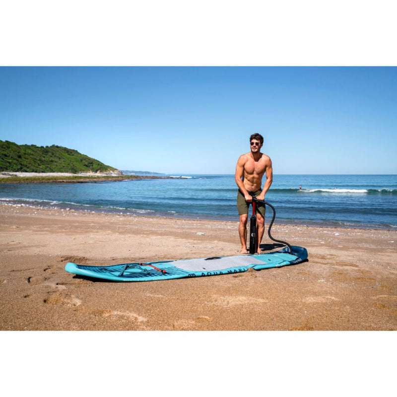 Man Using Air Pump to Inflate Aqua Marina Beast SUP on Beach