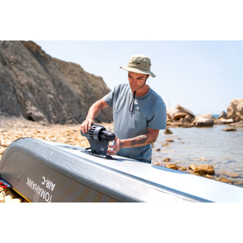 Man Attaching Aqua Marina BlueDrive K to Bottom of Tomahawk Inflatable Canoe