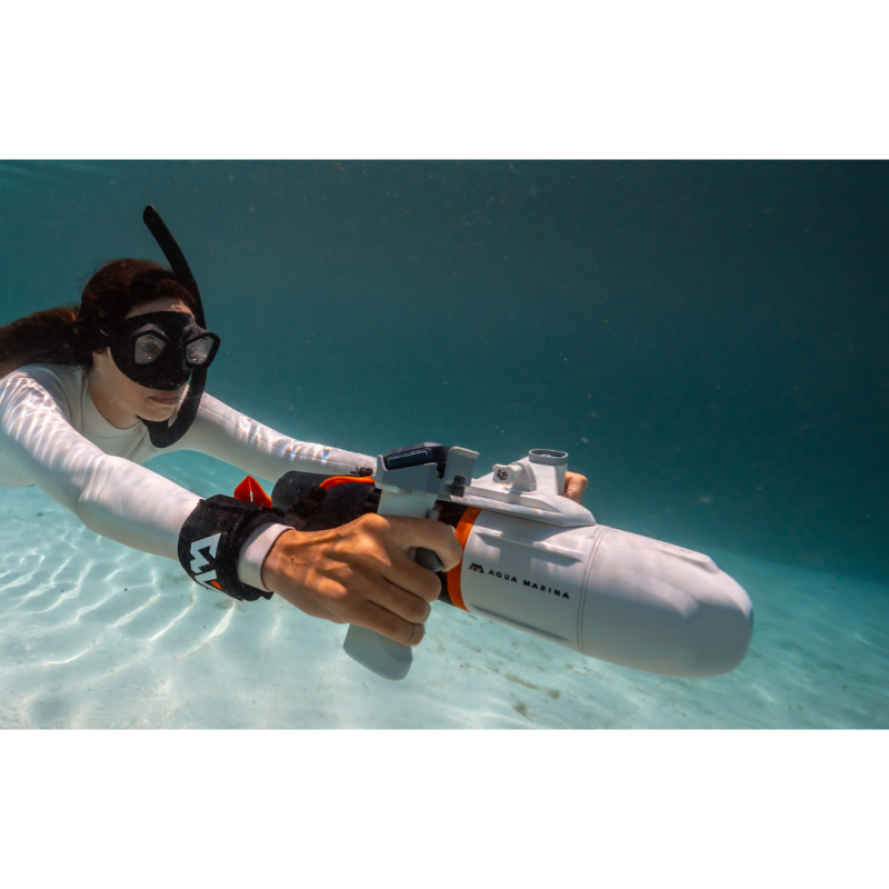 Woman using Aqua Marina BlueDrive X Electric Underwater Jet while diving in ocean close up view