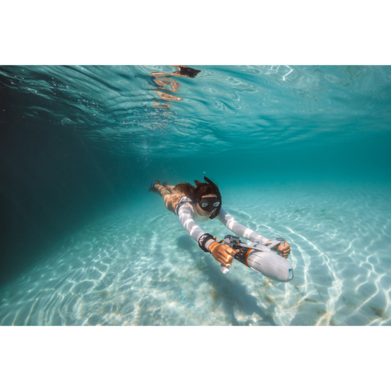 Woman using Aqua Marina BlueDrive X Pro Electric Underwater Jet while Diving in Ocean