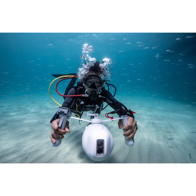 Man using Aqua Marina BlueDrive X Electric Underwater Jet while scuba diving in ocean front view