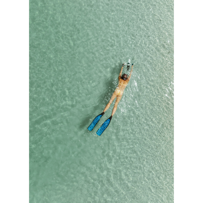 Woman using Aqua Marina BlueDrive X Pro Electric Underwater Jet while swimming in ocean