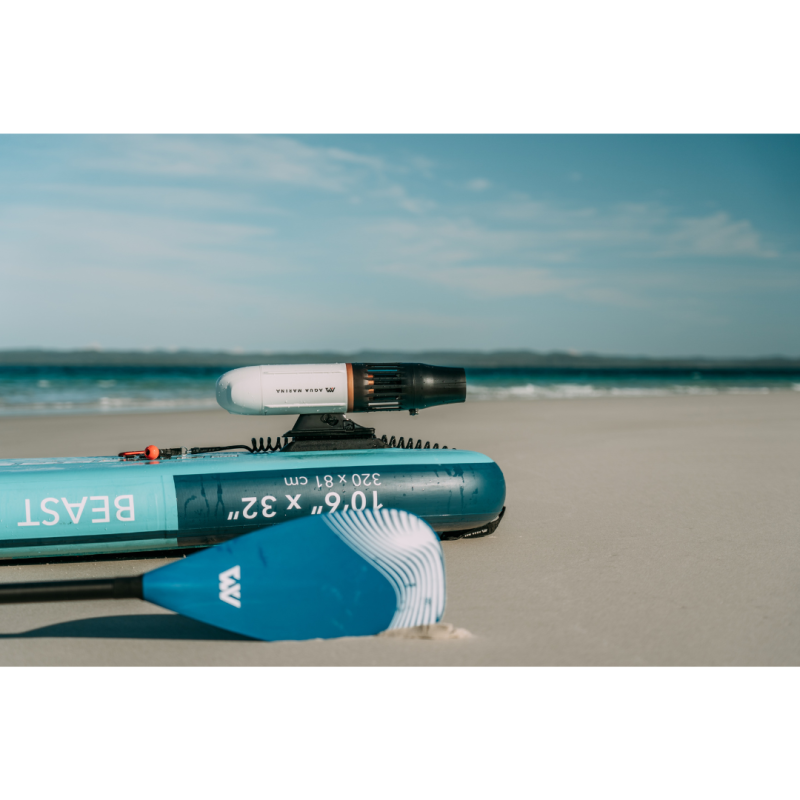 Aqua Marina BlueDrive X Electric Underwater Jet attached to SUP on beach