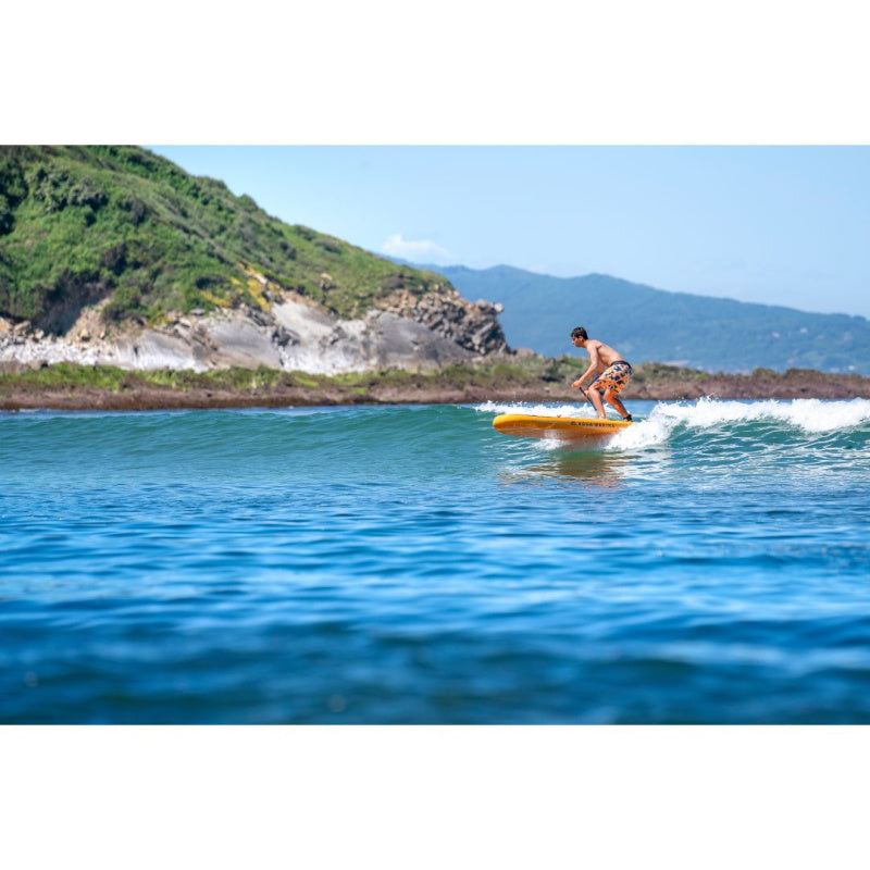 Man Riding Ocean Waves on Aqua Marina Fusion Inflatable SUP