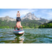 Man Doing Handstand on Aqua Marina Hyper Inflatable SUP on Lake in Front of Moutains