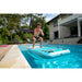 Man Doing Squat On Aqua Marina Peace Inflatable Fitness Mat in Pool Front View