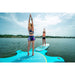 1 Girl Standing on SUP Attached to Yoga Dock & Instructor Standing on Yoga Dock in Water