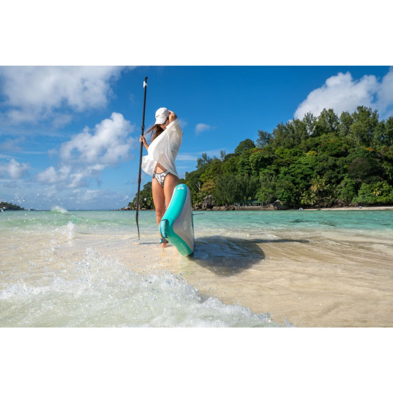 Woman on Shallow Beach Holding Paddle with Sipaboards Drive Tourer Electric SUP Leaning Against Her