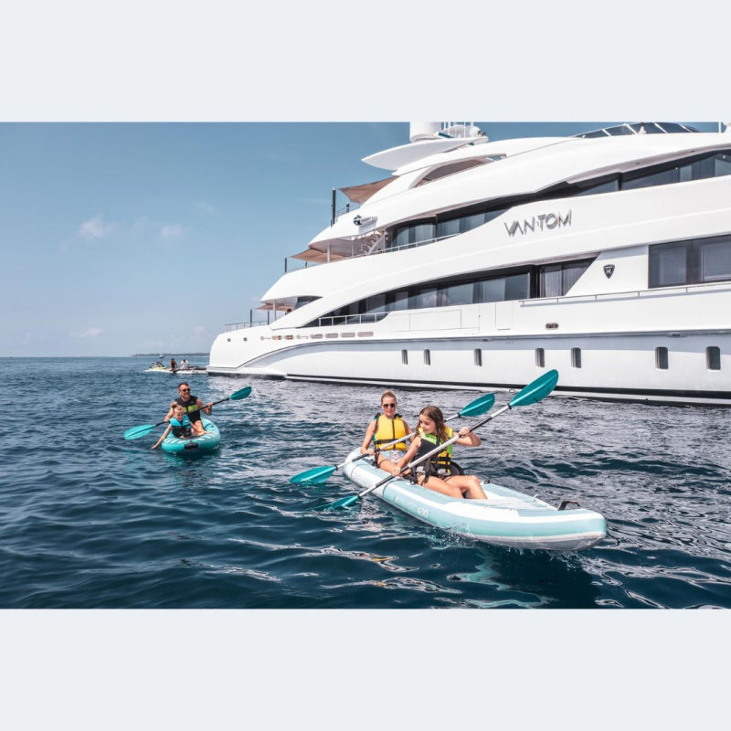 Woman and Child Paddling Spinera Adriatic 140 Inflatable Kayak in Front of Superyacht