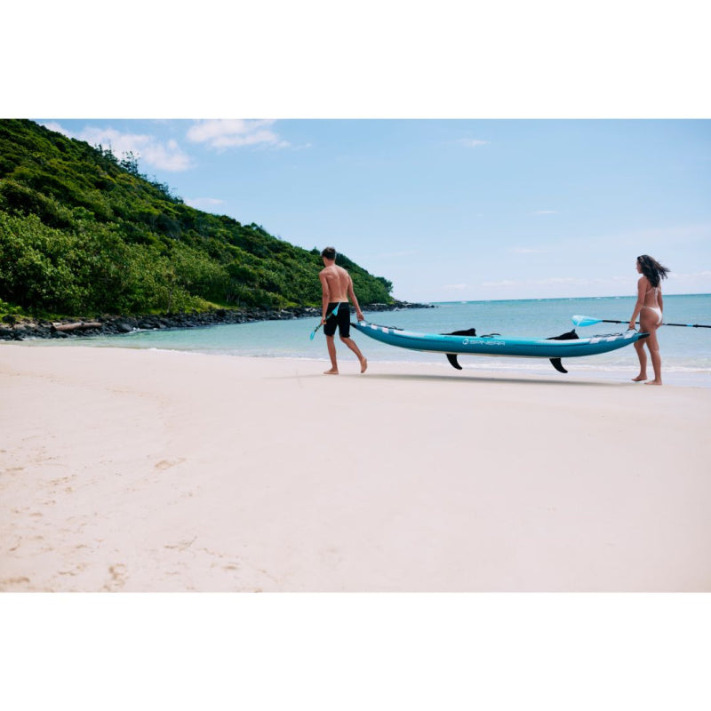 Man and Woman Carrying Spinera Hybris 410 Inflatable Kayak on Beach Left Side View