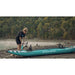 Woman Pumping Up Spinera Hybris 410 Inflatable Kayak on Beach Left Side View