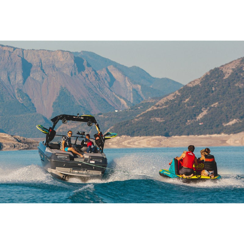 Spinera Let's Go 4 Family Towable 4 Person Tube - People Riding Tube Behind Boat on the Right