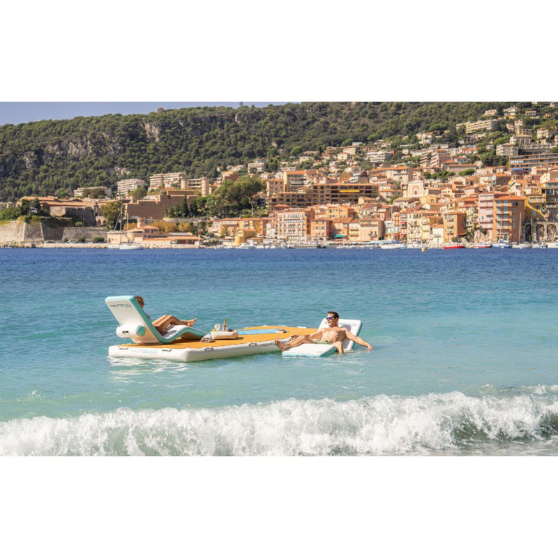 Yachtbeach Superior Sun Lounger Single - Man on Lounger in Water Next to Floating Platform with Woman on Lounger