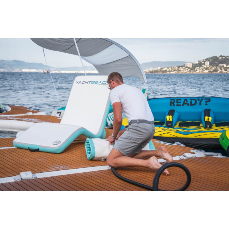 Yachtbeach Superior Sun Lounger Single - Man Deflating 
and Rolling Lounger with Inflated Lounger Behind